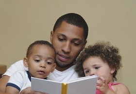 Man reading to his kids